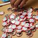 Mini Maker Faire buttons are grabbed at the entrance of the Morris Lawrence Building on Saturday, June 8. Daniel Brenner I AnnArbor.com